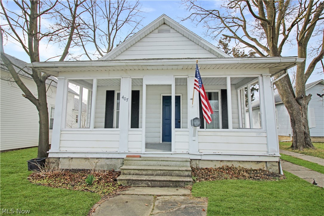 407 Fremont Road Port Clinton, OH 43452 - Photo 1 of 22 Bungalow-style house with covered porch and a front yard