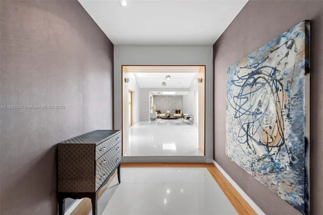 a view of hallway with livingroom and a livingroom with furniture