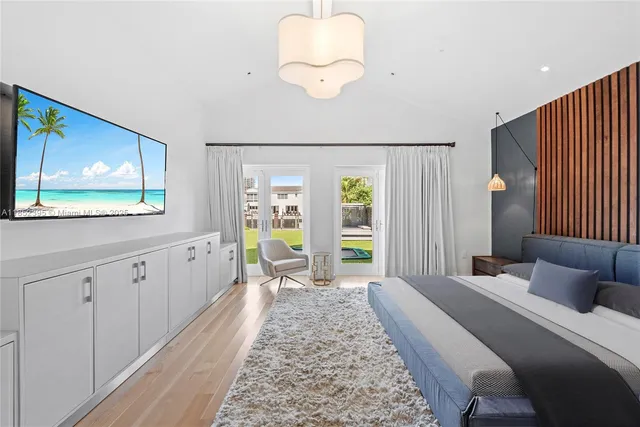 a large bedroom with a bed and glass windows