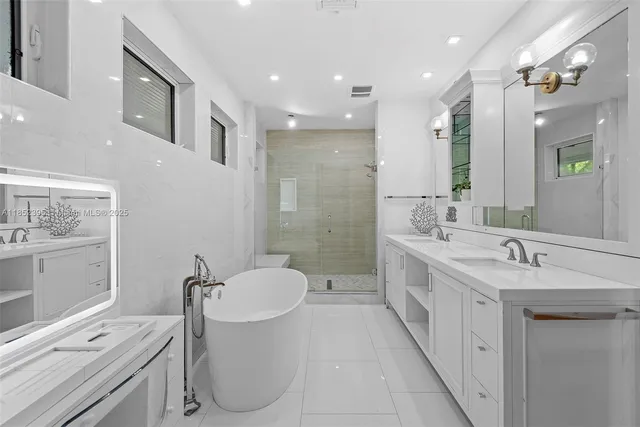 a bathroom with a double vanity sink a toilet and shower
