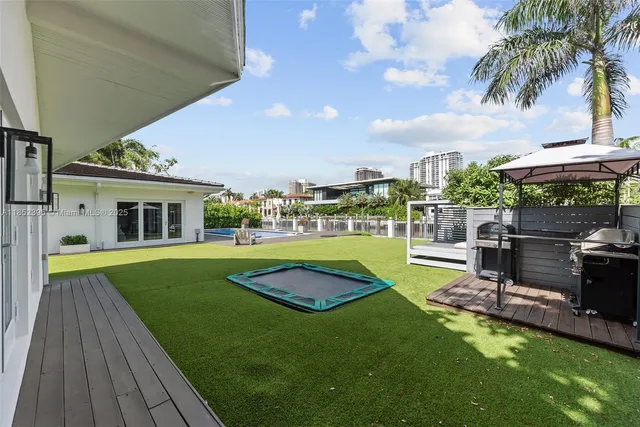 a view of a house with a swimming pool and a yard