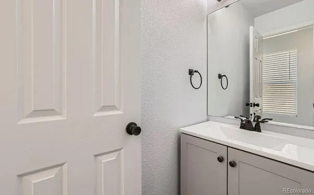 a bathroom with a sink and mirror