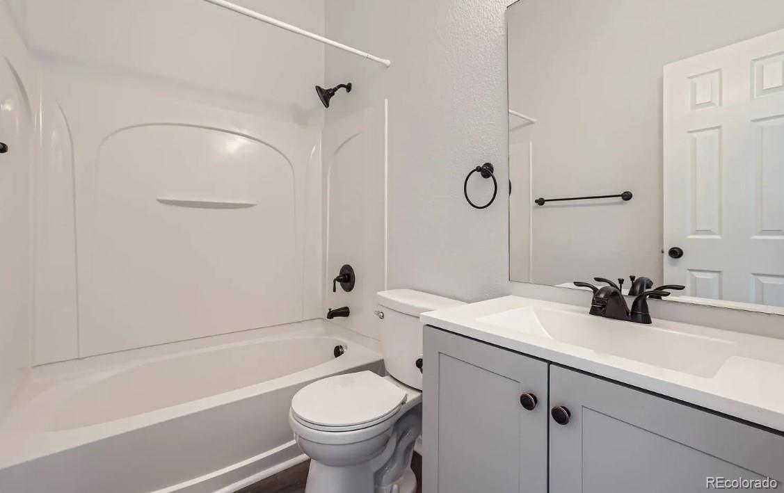 5925-5943 University Village View Colorado Springs, CO 80918 - Photo 15 of 21 a bathroom with a sink and a mirror
