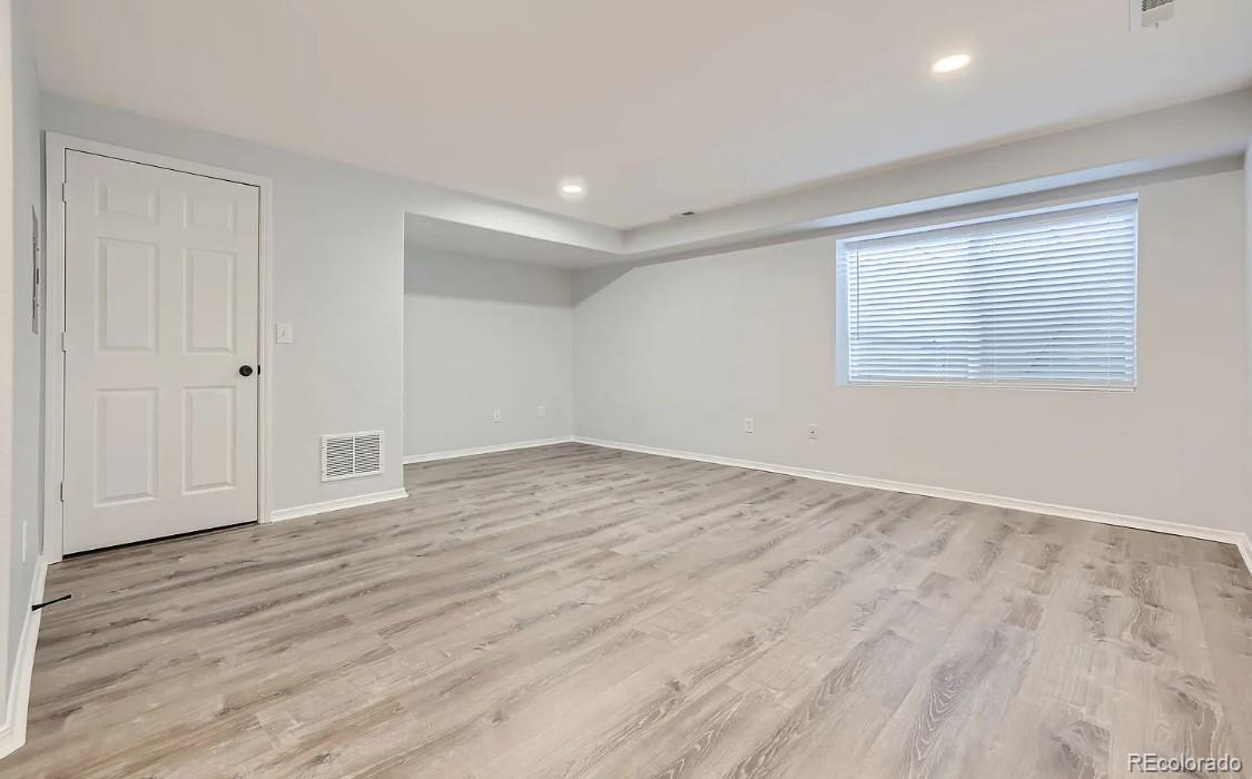 5925-5943 University Village View Colorado Springs, CO 80918 - Photo 17 of 21 a view of an empty room with wooden floor and a window