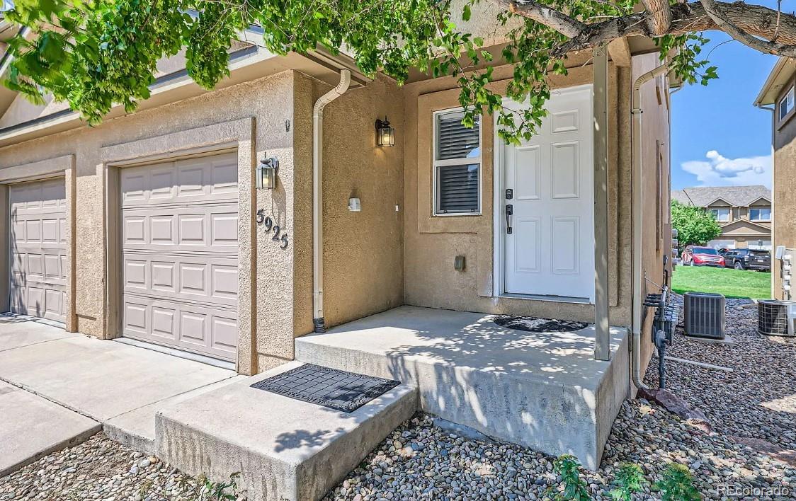 5925-5943 University Village View Colorado Springs, CO 80918 - Photo 3 of 21 a bath room with a bench and trees