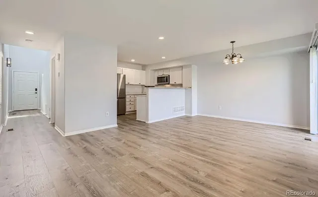 a view of a kitchen with a sink and a refrigerator