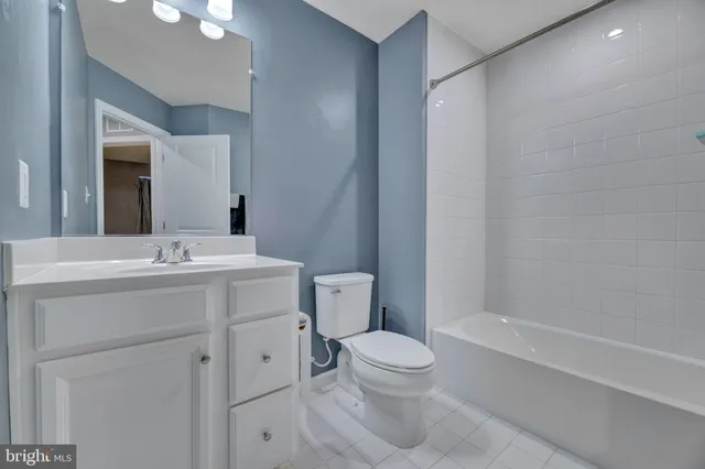 a bathroom with a toilet sink and a mirror