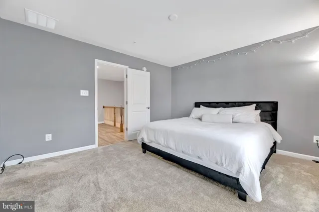 a bedroom with a bed and a night stand