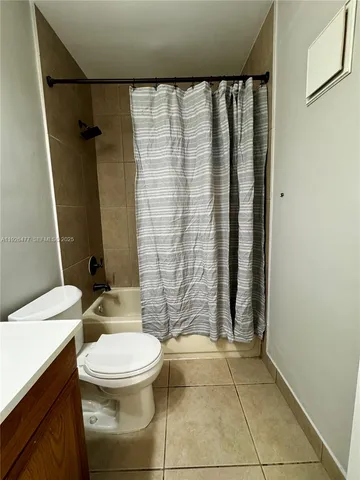 a bathroom with a toilet and shower