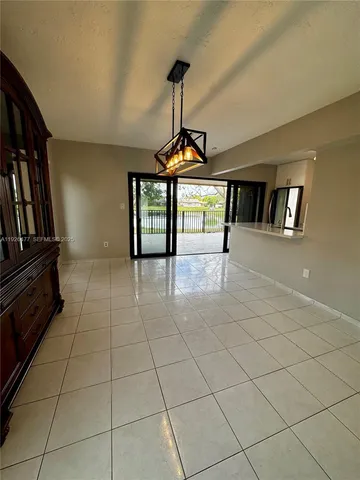 a view of a livingroom with furniture staircase and a ceiling fan