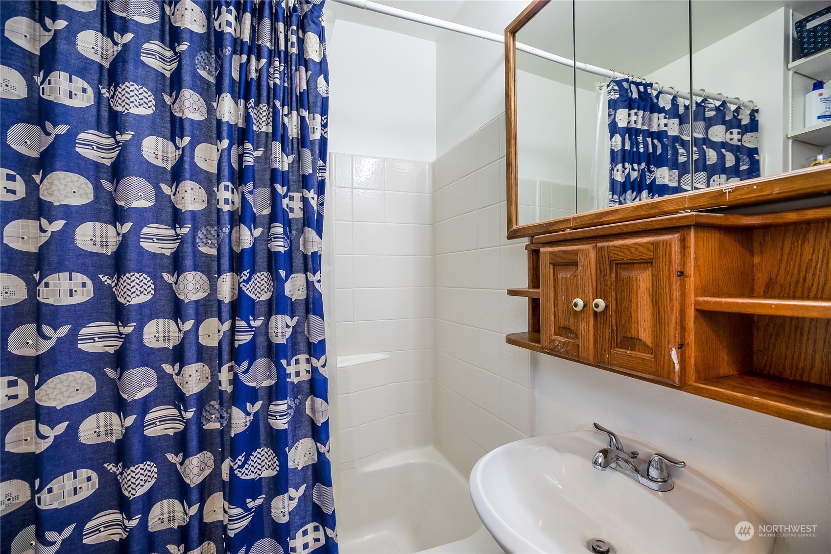 24 157th Place Southeast Bothell, WA 98012 - Photo 22 of 27 a bathroom with a sink and a shower curtain