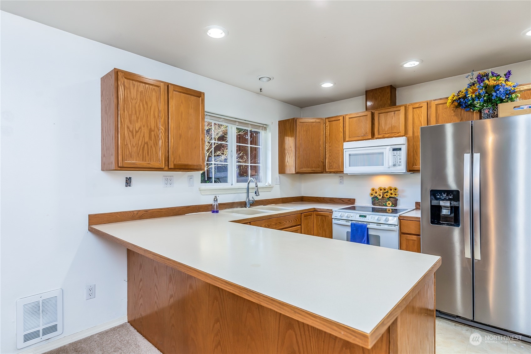24 157th Place Southeast Bothell, WA 98012 - Photo 5 of 27 a kitchen with stainless steel appliances a refrigerator and a sink