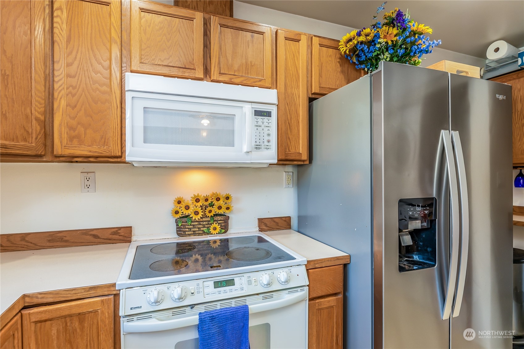 24 157th Place Southeast Bothell, WA 98012 - Photo 6 of 27 a kitchen with stainless steel appliances granite countertop a refrigerator a stove a microwave and cabinets