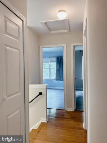 a view of hallway with wooden floor