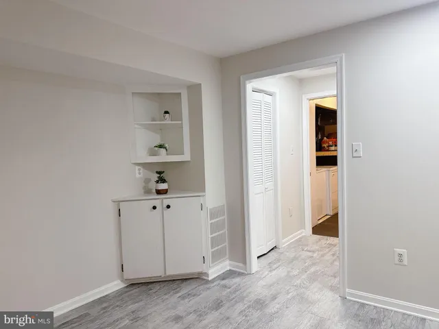 an empty room with closet and wooden floor