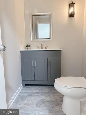 a bathroom with a sink a toilet and mirror