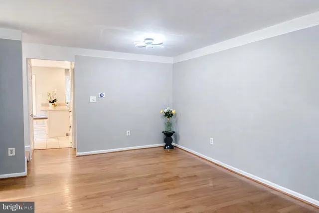 a view of a room with wooden floor and a window