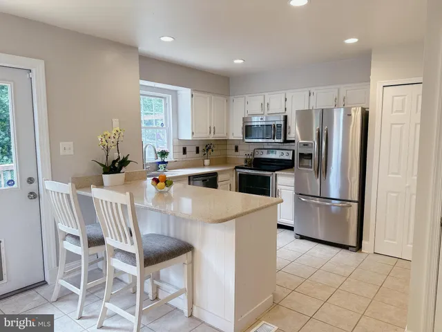 a kitchen with stainless steel appliances a refrigerator stove microwave and cabinets
