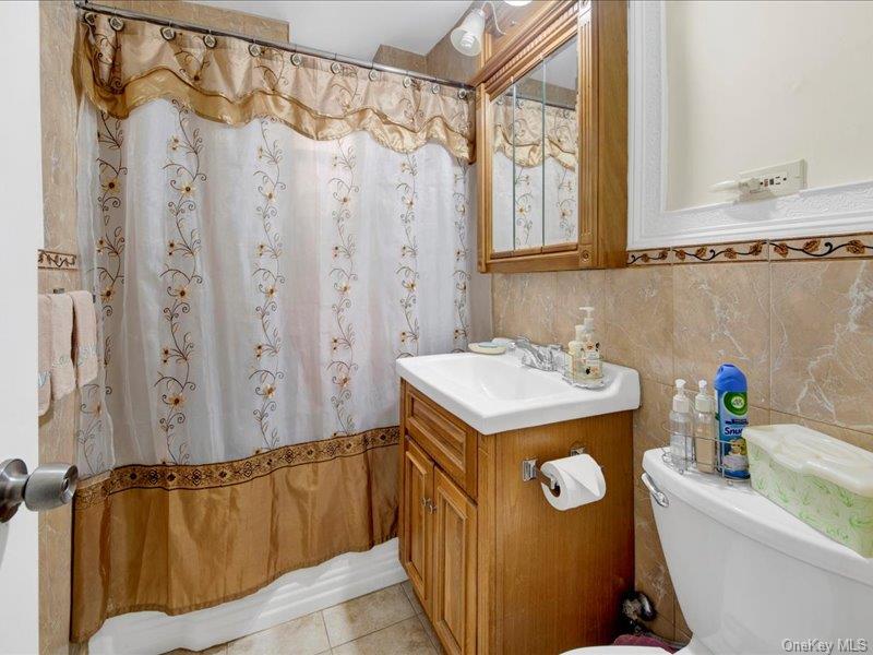 814 Tilden Street, Unit STB Bronx, NY 10467 - Photo 16 of 18 a bathroom with a sink a mirror and a shower