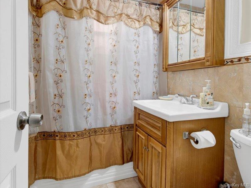 814 Tilden Street, Unit STB Bronx, NY 10467 - Photo 17 of 18 a bathroom with a sink and a mirror