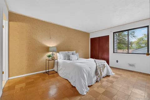 a bedroom with a bed and a window