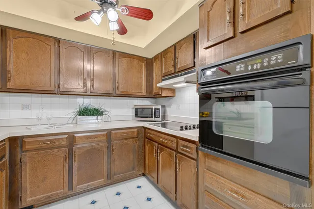 a kitchen with a sink cabinets and appliances