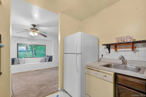 a kitchen with a refrigerator sink and cabinets