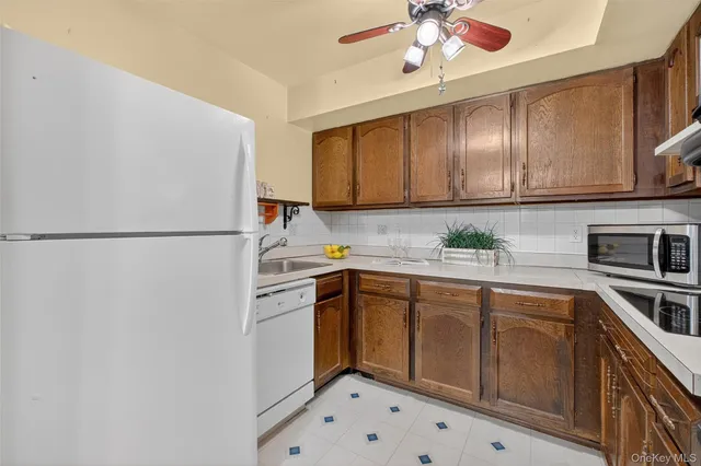 a kitchen with a sink stainless steel appliances and cabinets