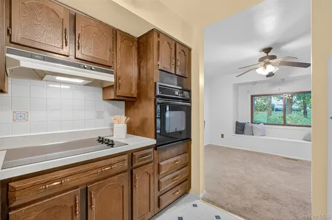 a kitchen with stainless steel appliances a sink stove and cabinets