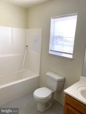 a utility room with wooden floor washer and dryer