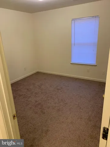 a kitchen with a stove and white cabinets
