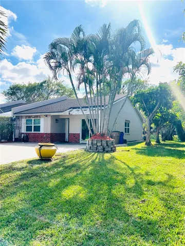 a front view of house with yard and outdoor seating
