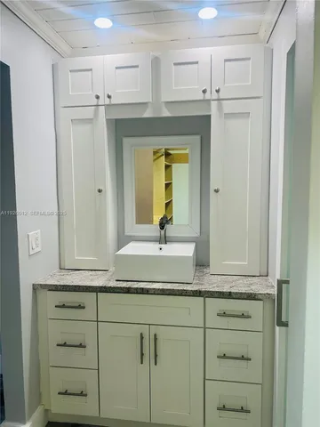 a backyard of a house with a garden and outdoor seating