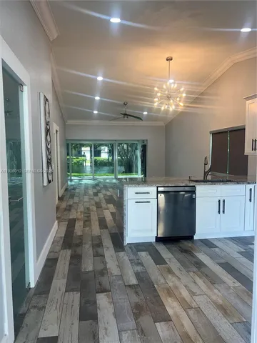 a large white kitchen with a large window