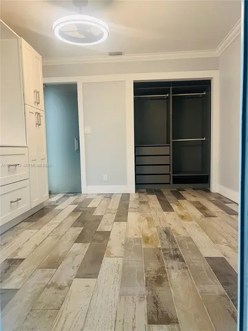 a bathroom with a granite countertop toilet sink and mirror