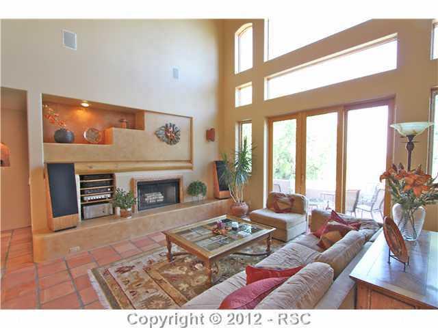 16 West Point Road Colorado Springs, CO 80906 - Photo 6 of 25 Another view of this exquisite living room featuring a gas fireplace, built in media shelves and a lighted decor section perfect for displaying treasured pieces. Built -in speaker system throughout the home provides the perfect ambiance.