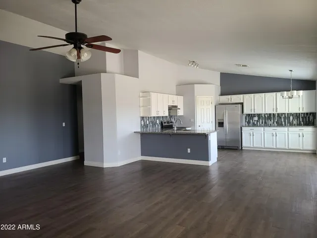 a view of a kitchen with wooden floor and a sink