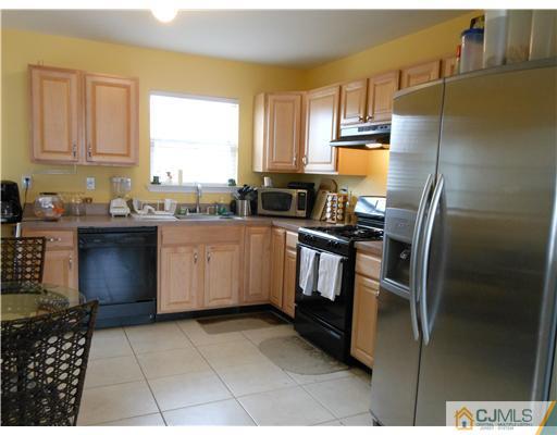 18 Caldwell Road Edison, NJ 08817 - Photo 4 of 11 a kitchen with stainless steel appliances granite countertop a sink stove and refrigerator