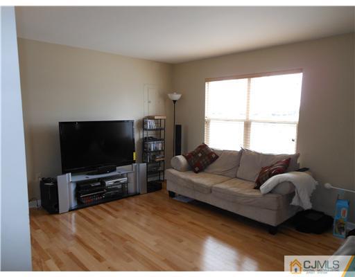 18 Caldwell Road Edison, NJ 08817 - Photo 5 of 11 a living room with furniture and a flat screen tv