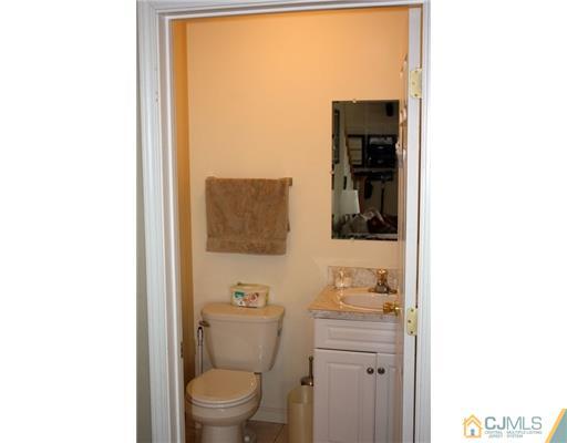 18 Caldwell Road Edison, NJ 08817 - Photo 8 of 11 a bathroom with a toilet a sink and mirror