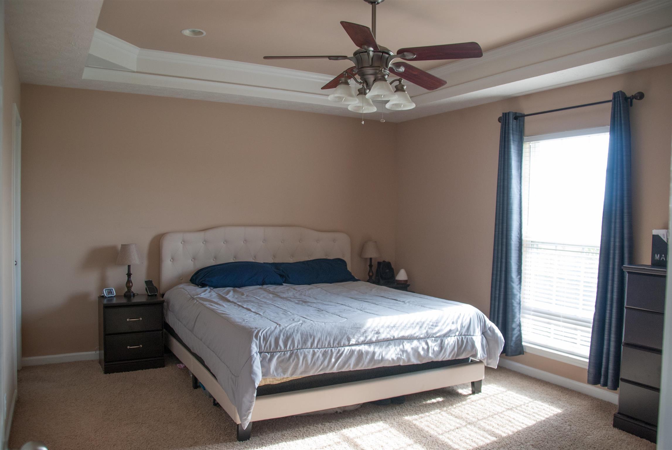 718 Lear Road Portland, TN 37148 - Photo 11 of 17 a bedroom with a bed and a chandelier