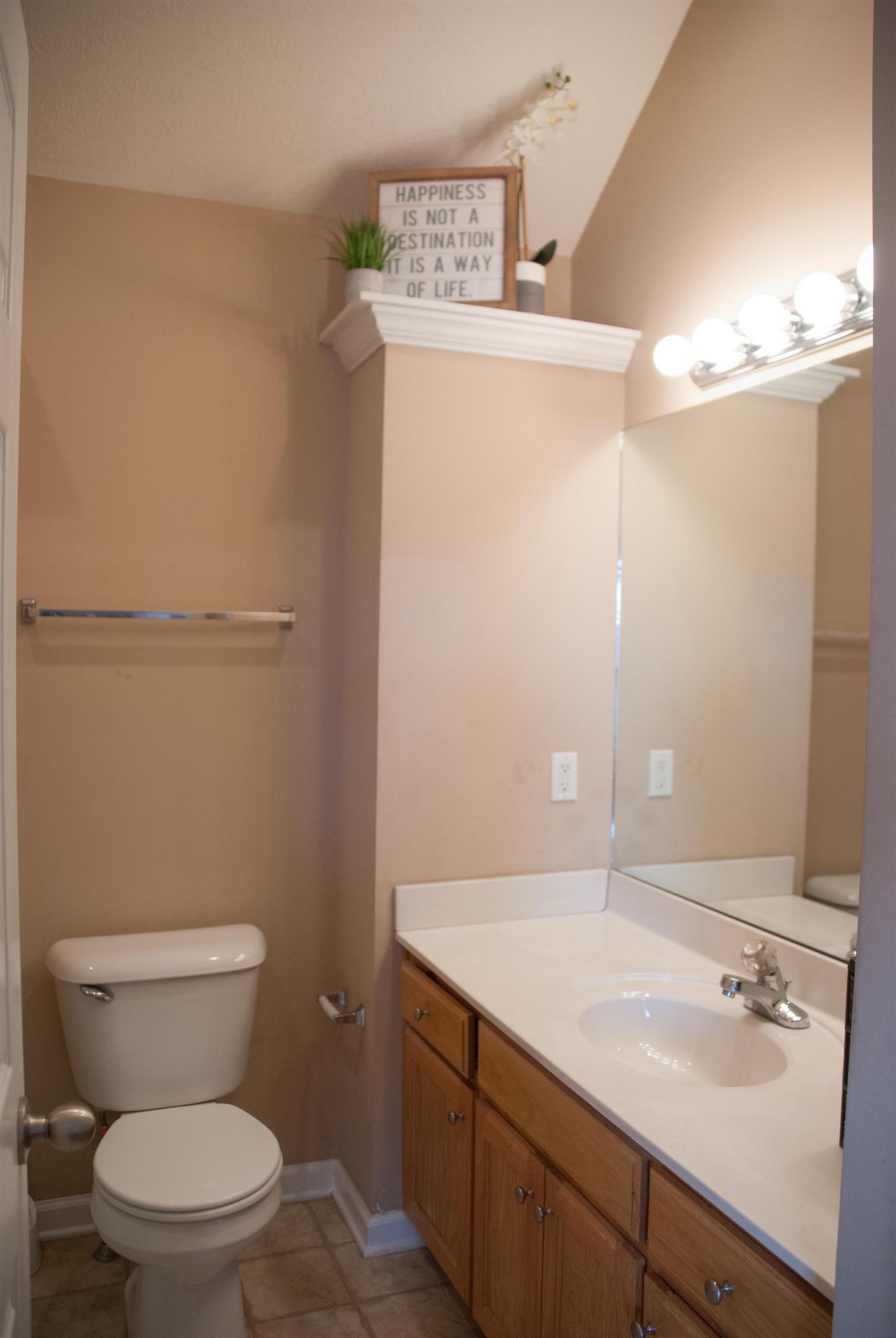 718 Lear Road Portland, TN 37148 - Photo 12 of 17 a bathroom with a granite countertop sink toilet and a mirror