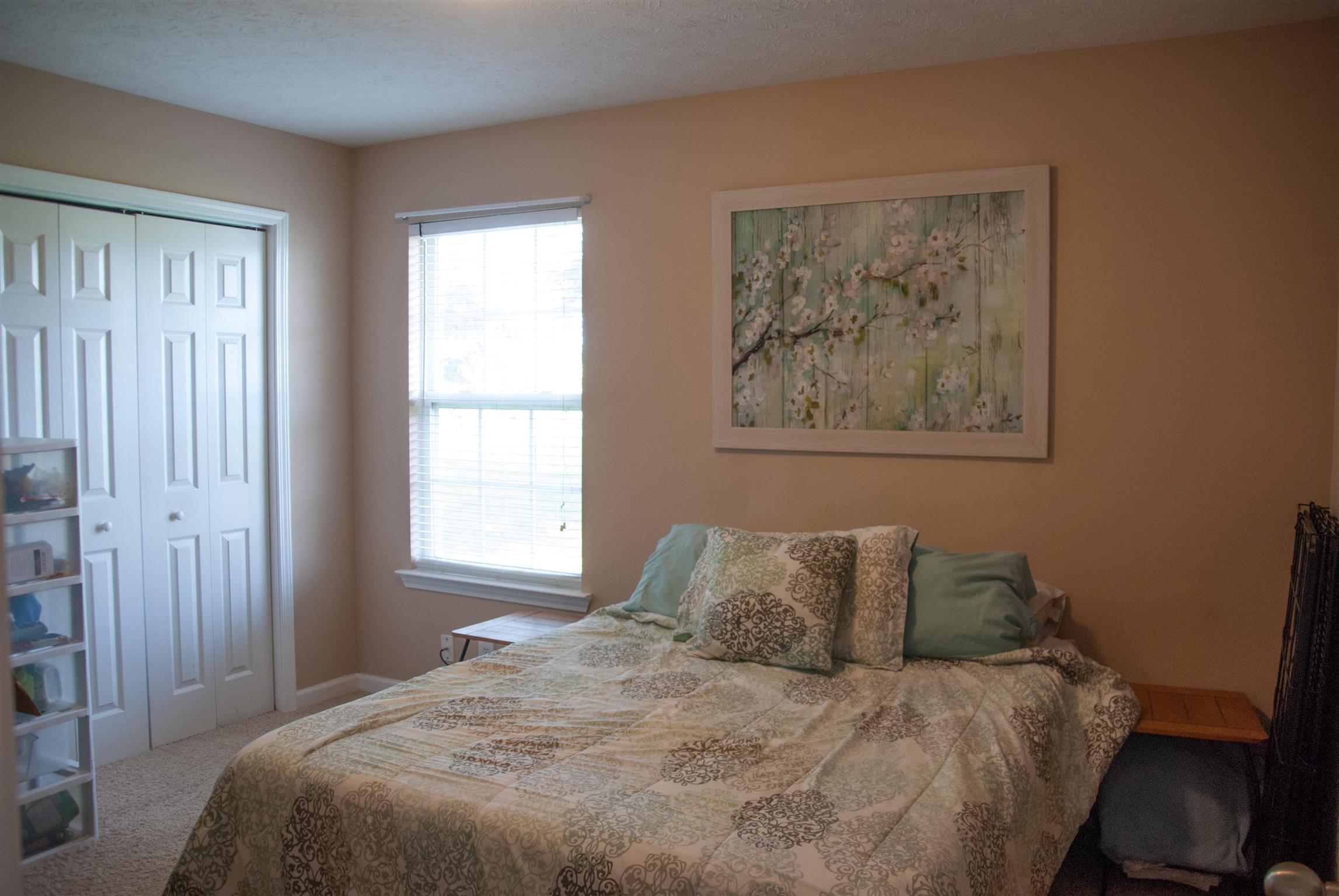 718 Lear Road Portland, TN 37148 - Photo 14 of 17 a large bed sitting in a bedroom next to a window