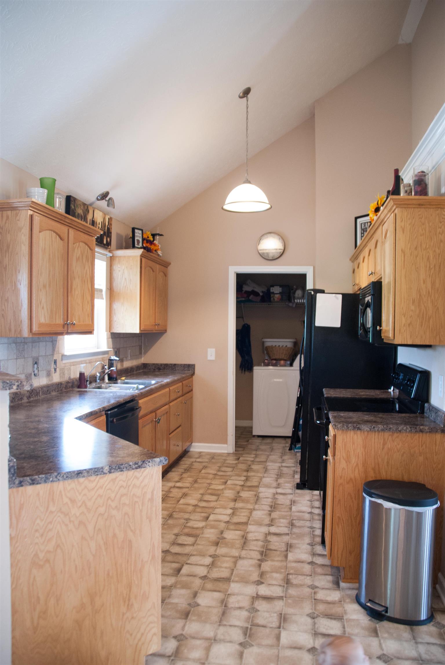 718 Lear Road Portland, TN 37148 - Photo 6 of 17 a kitchen with stainless steel appliances granite countertop a sink a stove and a refrigerator