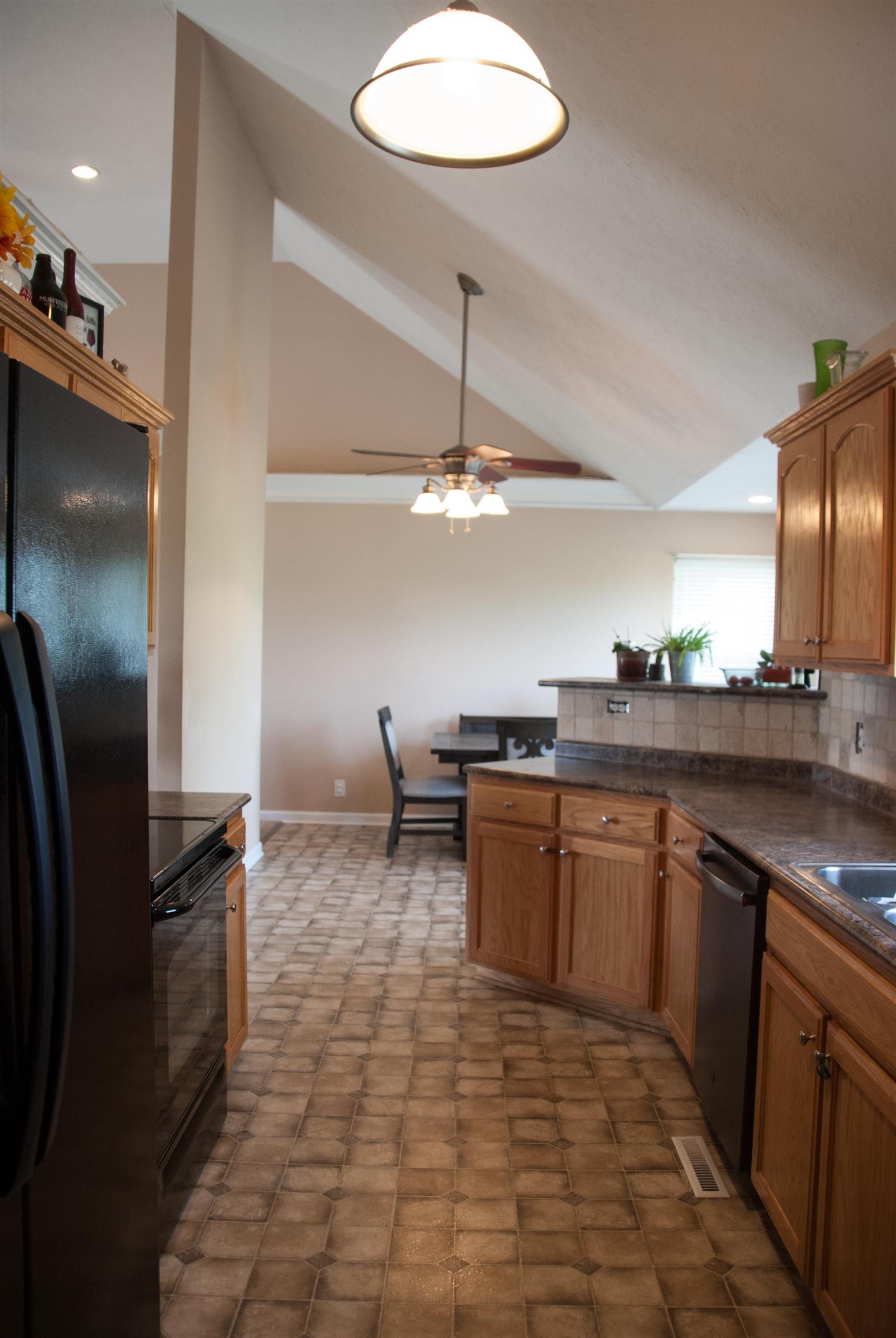 718 Lear Road Portland, TN 37148 - Photo 9 of 17 a kitchen with stainless steel appliances granite countertop a sink and a refrigerator