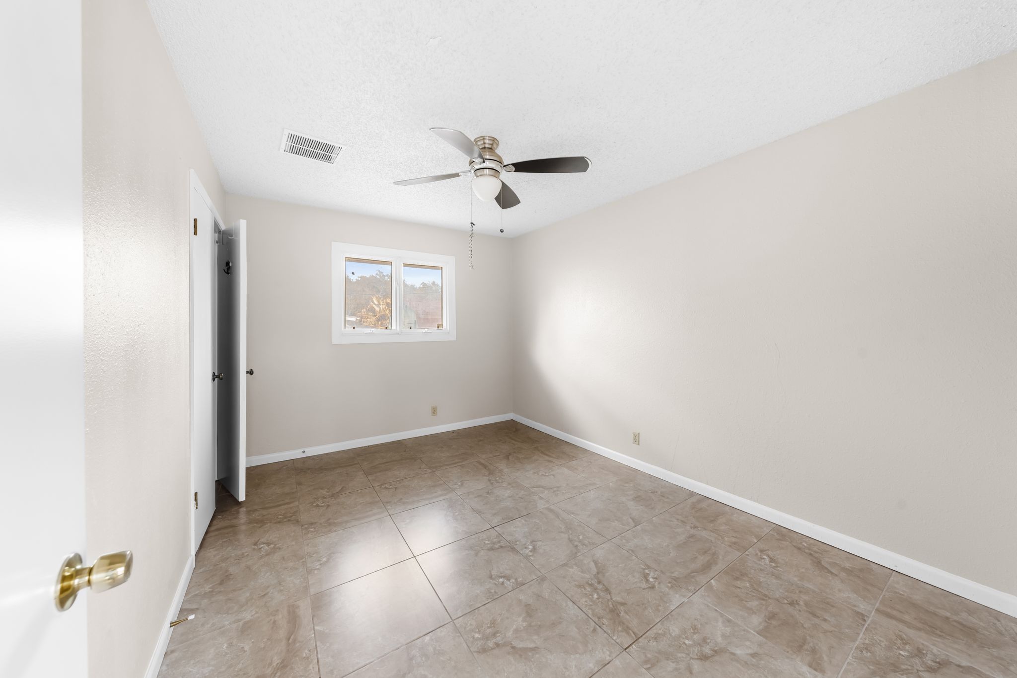13203 Stillforest Street Austin, TX 78729 - Photo 17 of 33 an empty room with windows and fan
