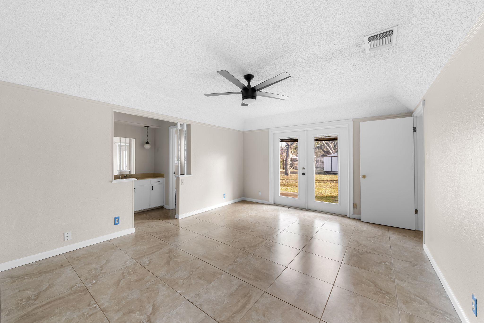 13203 Stillforest Street Austin, TX 78729 - Photo 21 of 33 a view of a livingroom with a window and a kitchen