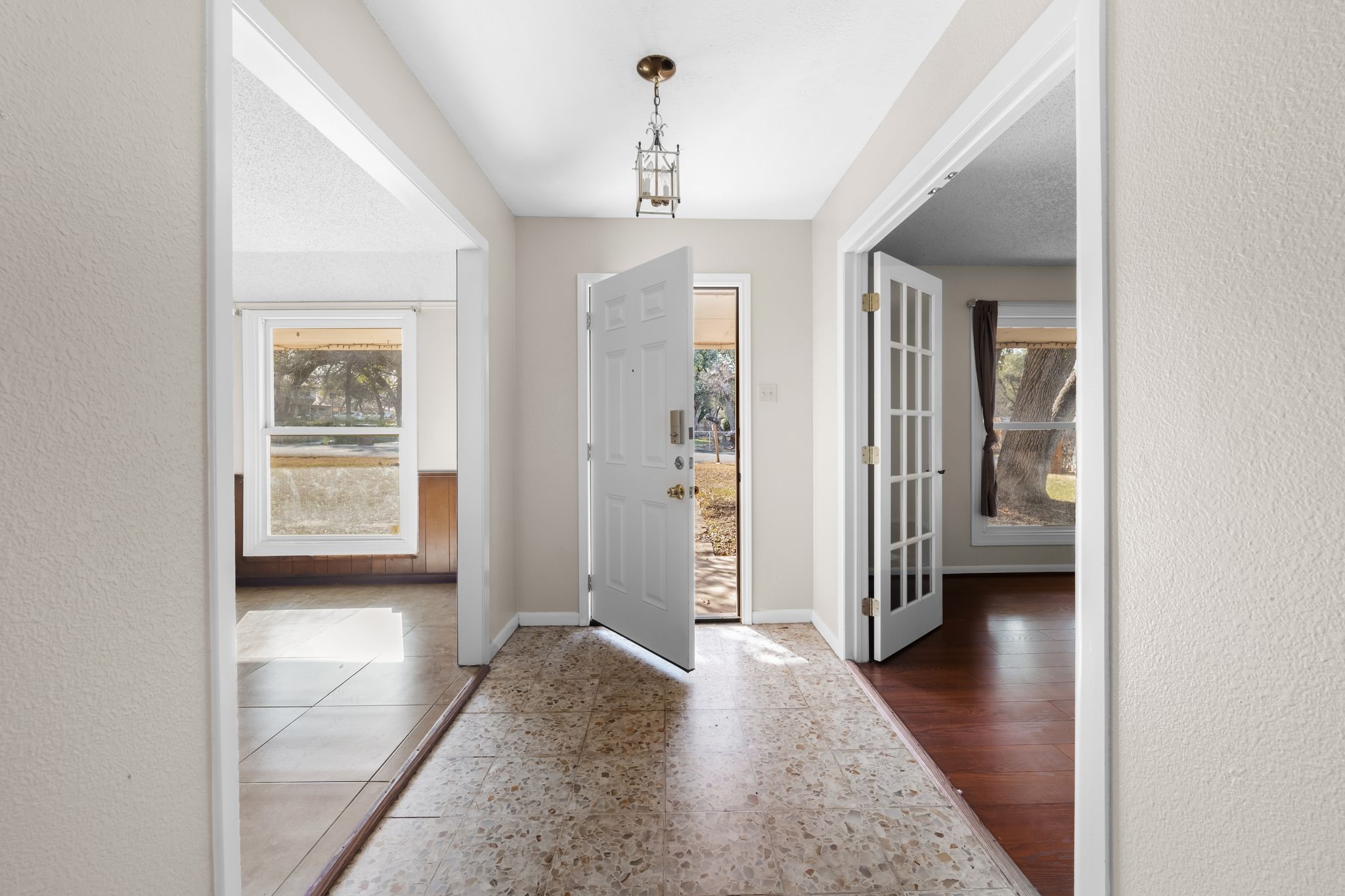 13203 Stillforest Street Austin, TX 78729 - Photo 4 of 33 a view of a hallway view with wooden floor and a living room
