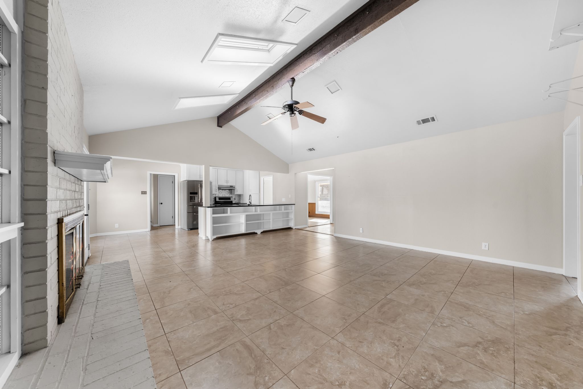 13203 Stillforest Street Austin, TX 78729 - Photo 9 of 33 a view of a kitchen with a sink and dishwasher a refrigerator with wooden floor