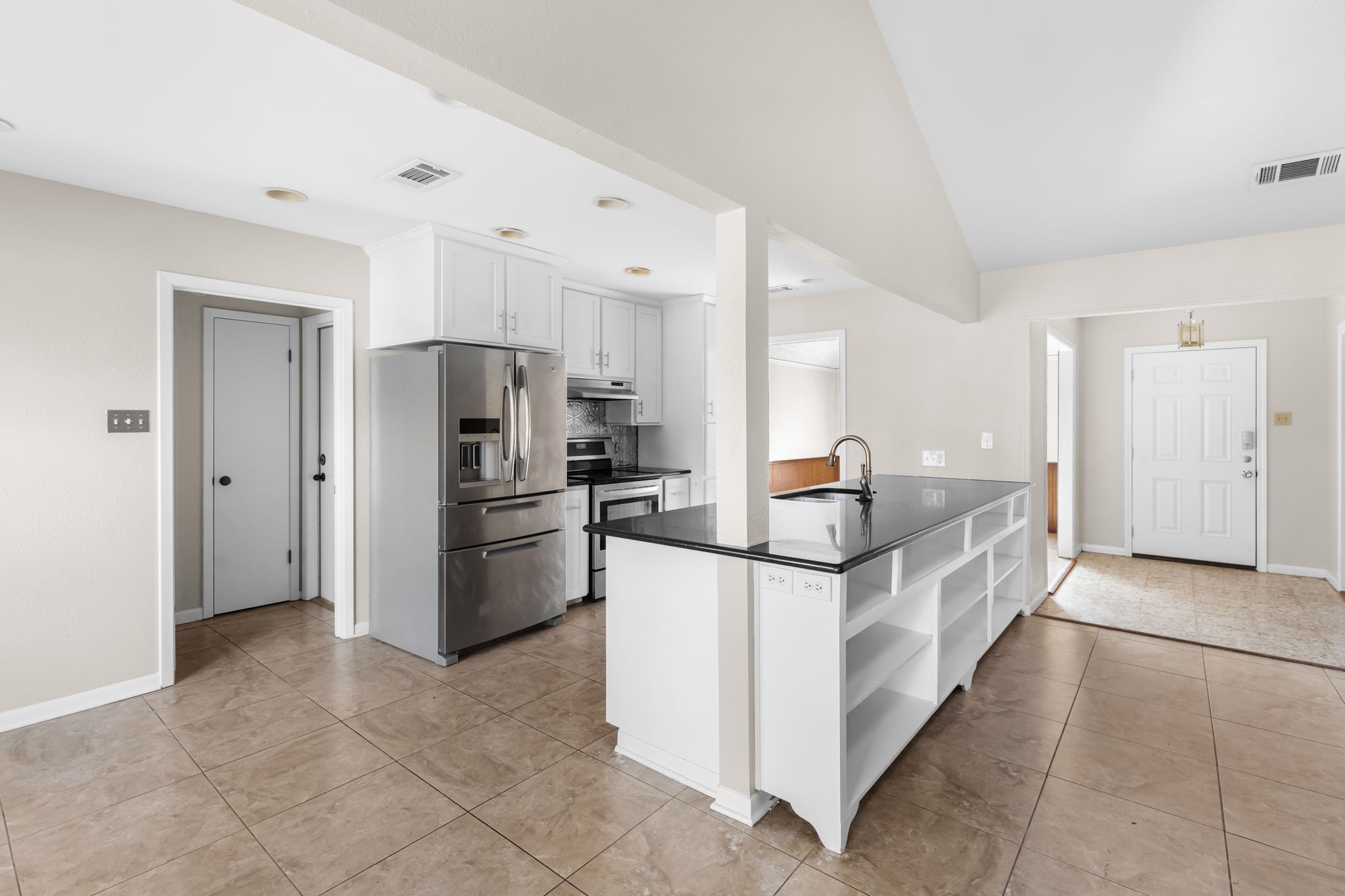 13203 Stillforest Street Austin, TX 78729 - Photo 10 of 33 a kitchen with stainless steel appliances granite countertop a refrigerator and a stove